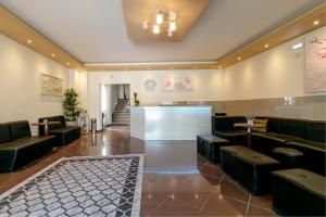 a waiting room with couches and a bar at Porto Marina Aparthotel in Gouvia