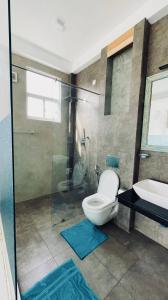 a bathroom with a toilet and a sink and a shower at Villa LA Kurumba in Ambalangoda