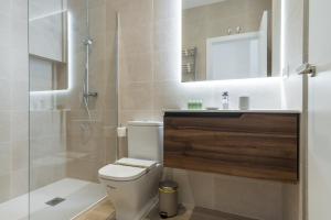 a bathroom with a toilet and a shower and a sink at Modern and Bright- 2 Bd 2 Bth - Center in Madrid