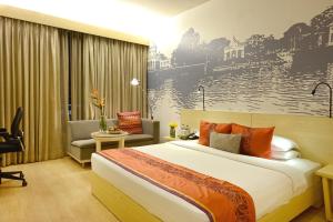 A bed or beds in a room at Vivanta Kolkata EM Bypass