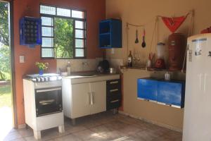 a kitchen with a sink and a stove at Refúgio Leve Amor in Águas de Lindóia +26 photos