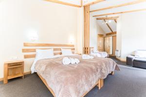 a bedroom with two beds with towels on them at Hotel Old Seti in Mestia