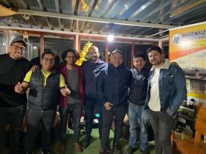 a group of men posing for a picture at Cuscungo Cotopaxi Hostel & Lodge in Chasqui