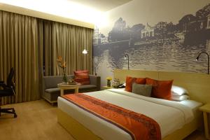 A bed or beds in a room at Vivanta Kolkata EM Bypass