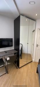 a living room with a glass partition with a desk at Lovely one bedroom flat in Hendon in The Hyde