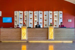 a lobby of a hotel with a reception counter at Sterling Puri in Puri