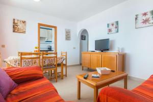 a living room with a couch and a table at Apartamento Calpeplaya - PlusHolidays in Calpe