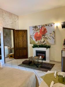 a living room with a fireplace and a table at Agriturismo Tenuta Carrino in Porto Cesareo