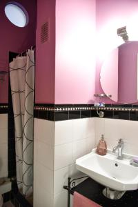 La salle de bains est pourvue d'un lavabo et d'un miroir. dans l'établissement Colourful Apt in Nea Smyrni, à Athènes