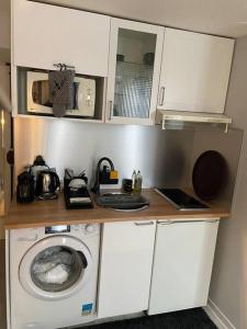 a small kitchen with a washing machine in it at Ile Saint Louis in Paris