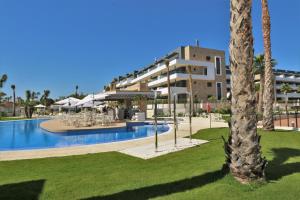 a resort with a swimming pool and a building at Flamenca Village south facing close to the beach (VDE-045) in Orihuela