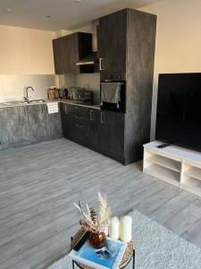 a living room with a large kitchen with a tv at Stylish Luxury new 2 bedroom Apartment in Dartford