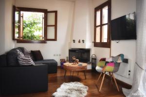 een woonkamer met een bank en een tafel bij Delfi's cozy maisonette in Delfoi