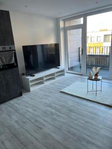 a living room with a large flat screen tv at Stylish Luxury new 2 bedroom Apartment in Dartford