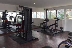 a gym with several tread machines in a room at The Base Hua Hin in Hua Hin