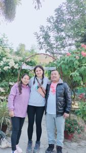 a group of three people posing for a picture at Hotel Garden of Dreams in Sauraha
