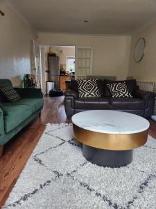 a living room with a couch and a coffee table at Room in Crawley/Gatwick/West Sussex in Ifield