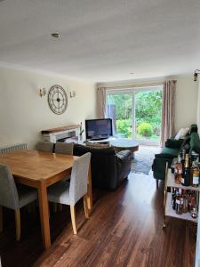 a living room with a couch and a table at Room in Crawley/Gatwick/West Sussex in Ifield