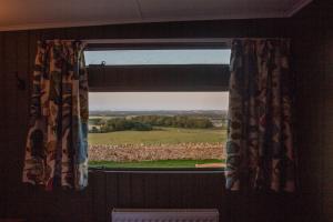 a window in a room with a view of a field at Middlemoor Farm Holidays in Alnwick