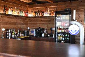 a bar with a counter with bottles of alcohol at Nostos Beachfront Apartments & Studios in Agios Ioannis