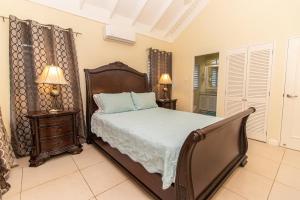 a bedroom with a bed and two night stands at DreamVilla Richmond Estates in Priory +30 photos