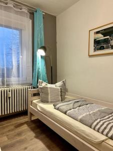 a bedroom with a bed and a window with a radiator at An der Linde in Kall