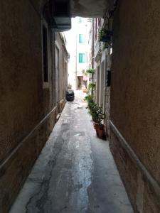 an empty alley with a car parked in the distance at Little Lion in Split