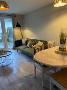 a living room with a couch and a table at Redmarley House 