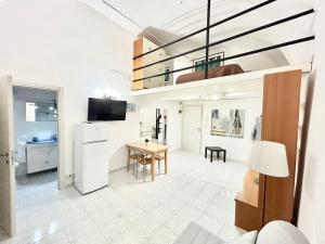 a kitchen and living room with a table and a chandelier at Antico Borgo - UN LETTO IDEALE in Gaeta