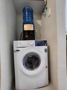 a washing machine with a cell phone on top of it at Aloha Ocean Garden Villas Boracay in Boracay