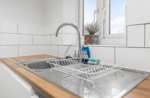 een gootsteen met een droogrek erop bij *NEW* 2 bed apartment on Ber St Norwich in Norwich