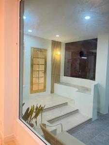 a room with a glass window with stairs in it at Sukwimol Place in Phitsanulok