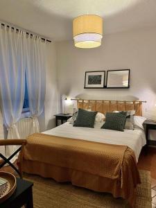a bedroom with a large bed with two pillows at Agriturismo Tenuta la Marchesa in Novi Ligure