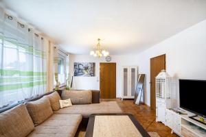 a living room with a couch and a tv at Traumschmiede in Bad Emstal