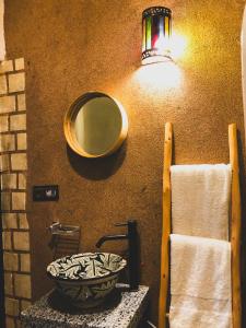 a bathroom with a sink and a mirror on a wall at Panorama Guesthouse in Agadir