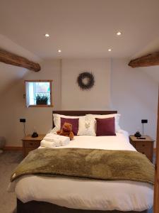 a bedroom with a large bed with teddy bears on it at Sanctuary inn in Bolsover