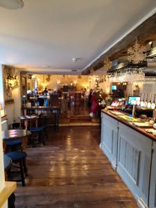 a restaurant with a bar with people in the background at Sanctuary inn in Bolsover