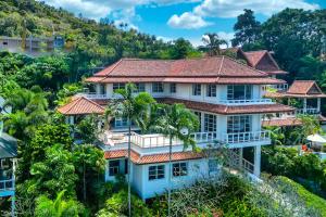 an aerial view of a house on a hill at Scenic Seaview Villa Sea Dream for 9, Tennis Court, 5min walk to Kata Noi Beach in Kata Beach