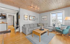 a living room with a couch and a table at Awesome Home In seral With House A Mountain View in Åseral