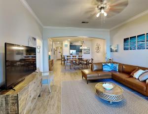 a living room with a couch and a flat screen tv at 832 Cinnamon Beach, 3 Bedroom, Sleeps 8, Ocean Front, 2 Pools, Elevator in Palm Coast