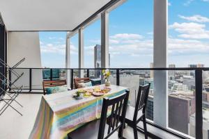 a dining room with a table and chairs on a balcony at Sky-City Apt 3 min to Train & Shopping& Everything in Sydney
