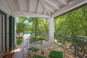 a patio with a table and chairs on a balcony at Villa Laura in Medulin for 8 persons only 1.5 km from the beach in Medulin