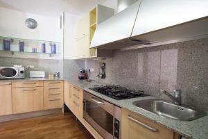 a kitchen with a sink and a stove at Canela Homes BARCELONA UNIVERSITAT in Barcelona