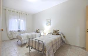a bedroom with two beds and a window at Nice Home In Villa S, Lucia With Outdoor Swimming Pool in La Volla