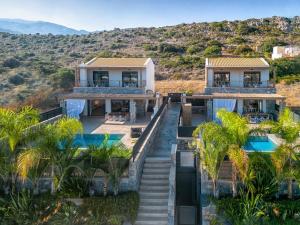 an aerial view of a house with palm trees at Calma Villas Crete - heated pool in Sissi