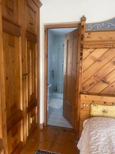 a bedroom with a bed and a bathroom with a shower at Bike and Ski dreams in Cortina dʼAmpezzo