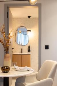 - une cuisine avec une table, une chaise et un miroir dans l'établissement Icon Apartments by NÔMA, à Porto