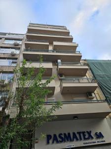 a tall building with a sign on the side of it at Syggrou Open View Apt in Thessaloniki