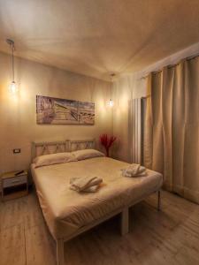 a bedroom with a bed with two towels on it at Foresteria Del Borgo Etrusco in Lonato del Garda