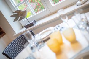 a bird statue sitting on a window sill next to a table at Suederhof 6 in Keitum